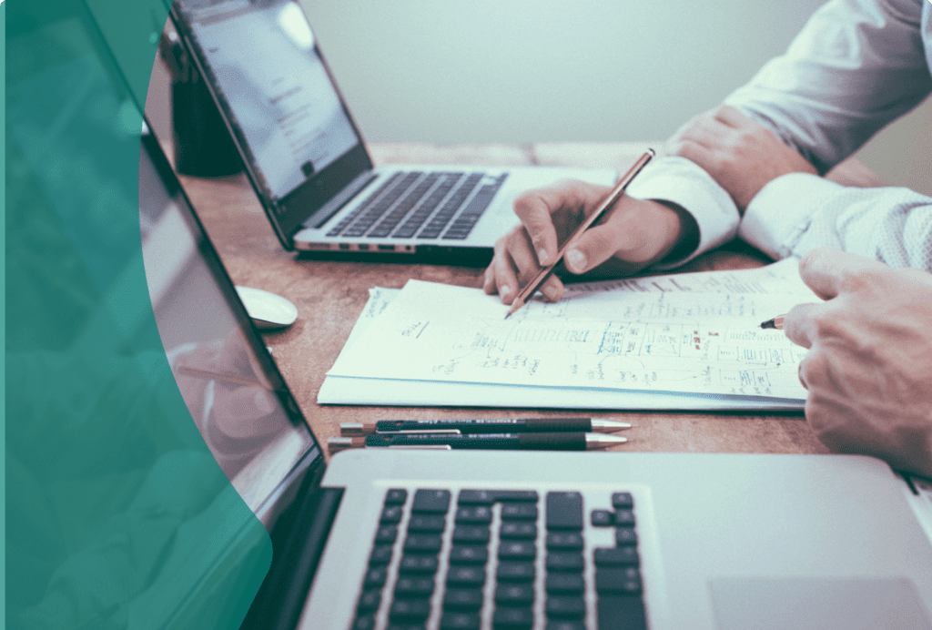 Two laptops with 2 sets of hands on them